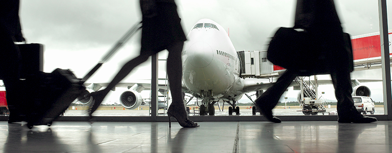 People walking through airport, silhouette (focus on aeroplane)