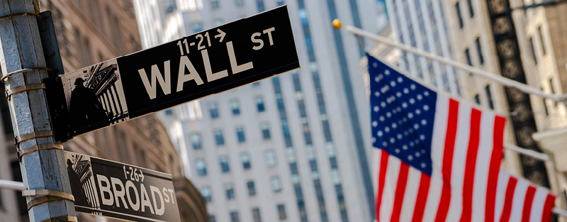 U.S. flag and Wall street sign in Manhattan's financial district.