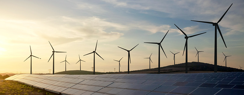 Solar panels and wind turbines generating renewable energy.