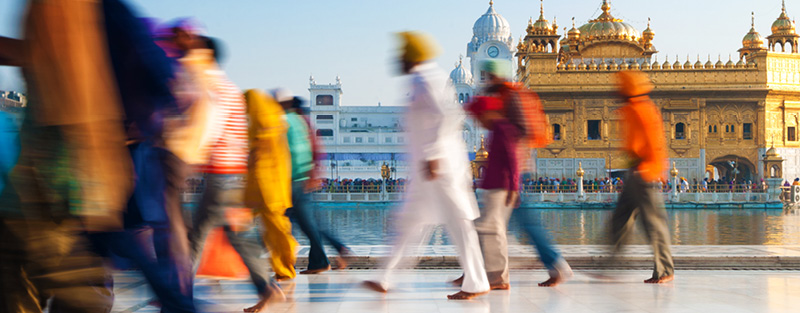 Group of Sikh pilgrims walking by the holy pool, Golden Temple, Amritsar, Pun jab state, India.