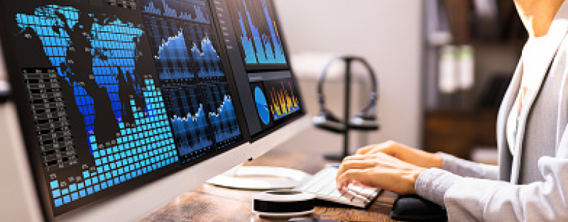 African American Business Data Analyst Woman Using Computer, global map and data on screen