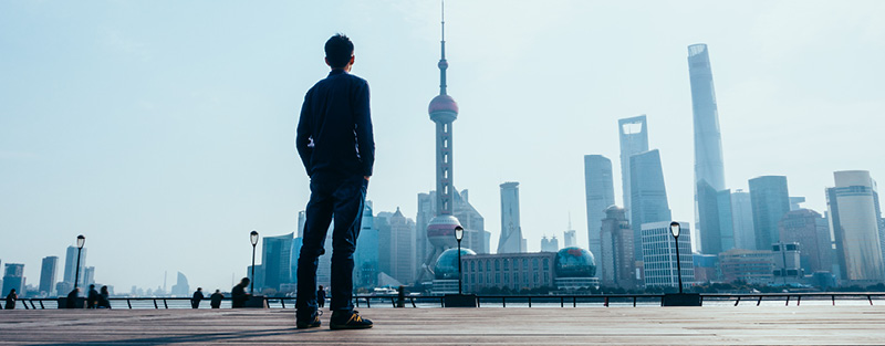 Man looking ahead at the Shanghai skyline.