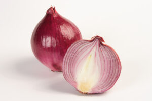 Two purple onions, one is halved revealing its layers.