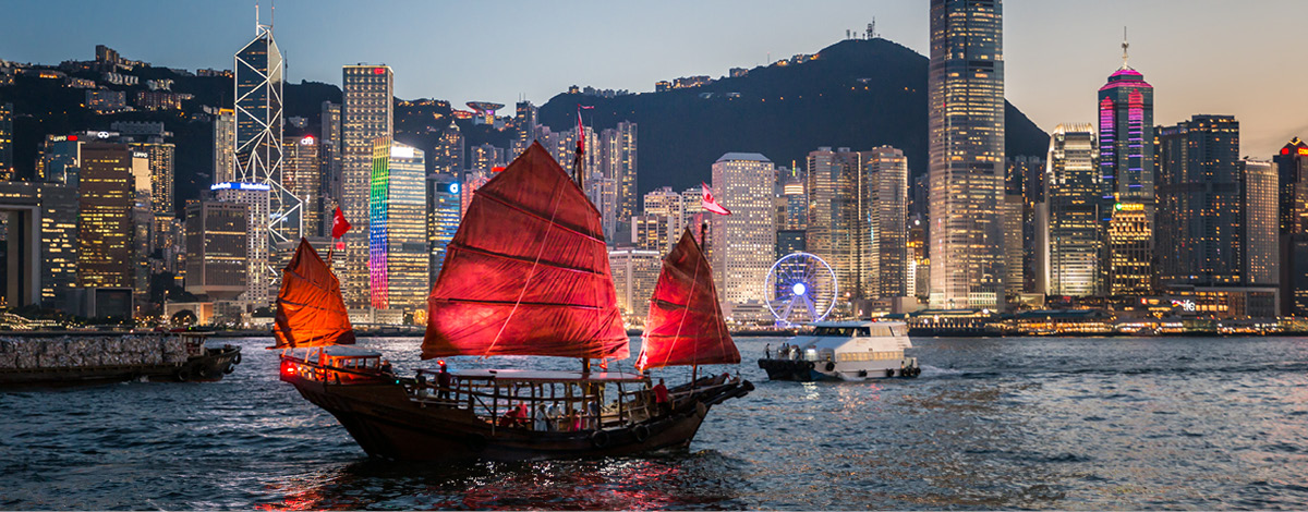 Traditional junk boat sailing across Victoria Harbour, Hong Kong.