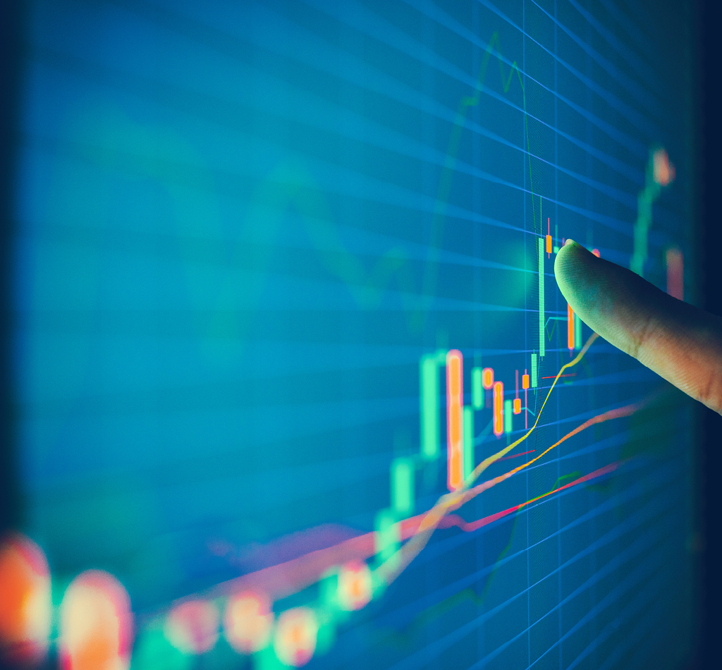 Closeup hand pointing finger on blue colour monitor to analyse stock market graph