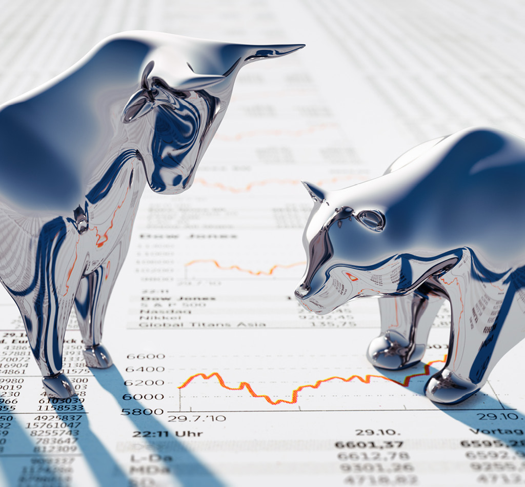 Silver Bull and Bear standing on a financial Newspaper with Charts.