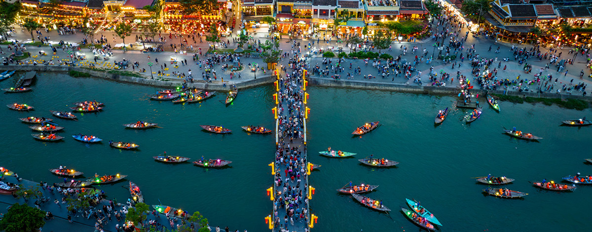 Aerial view of Hoai river with boat traffic at night in Vietnam.
