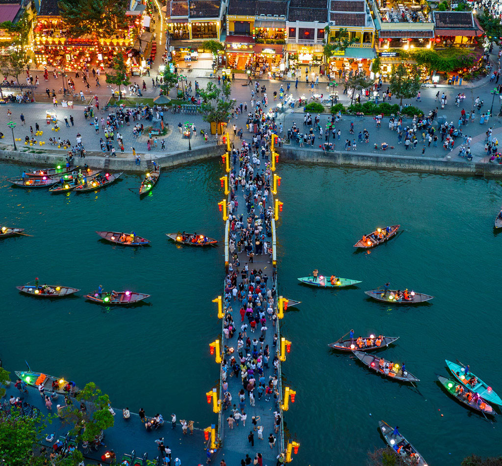 Aerial view of Hoai river with boat traffic at night in Vietnam.