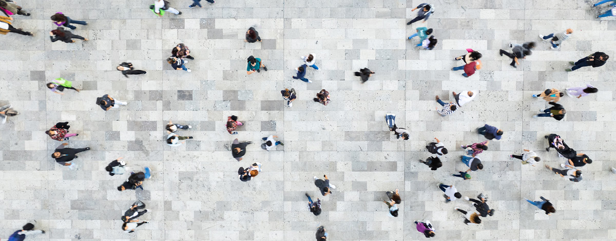 Aerial shot of a crowd of people walking in different directions.