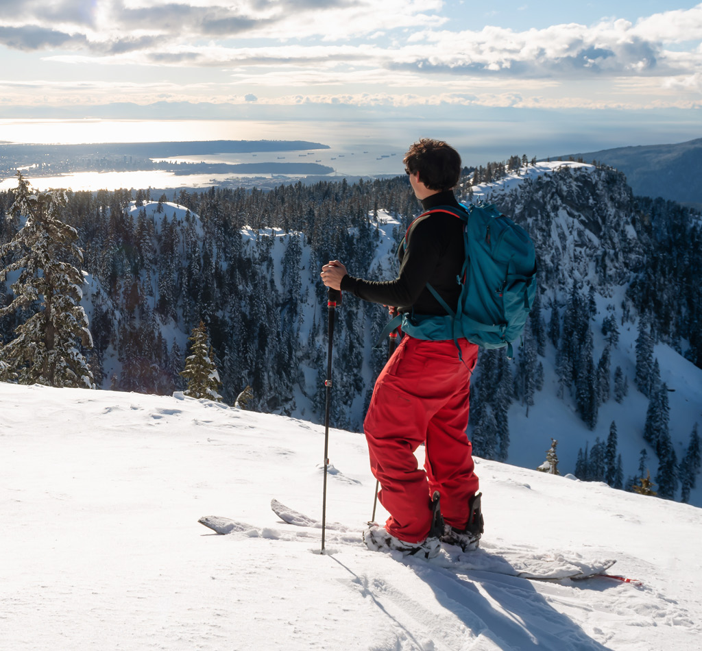 A person is backcountry skiing up Mount Seymour during a sunny winter day. Taken in North Vancouver, BC, Canada.