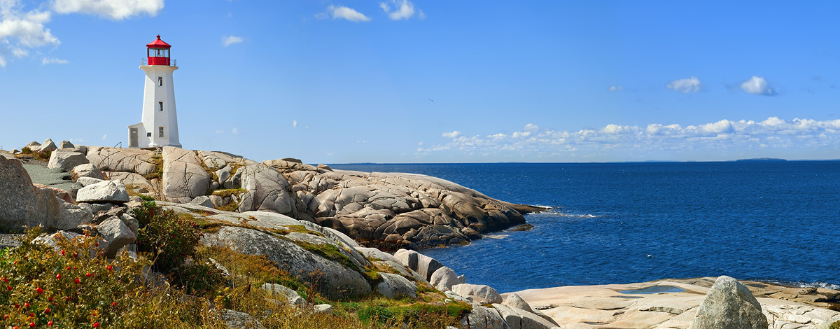 Nova Scotia's iconic Peggys Cove Lighthouse on a sunny day.