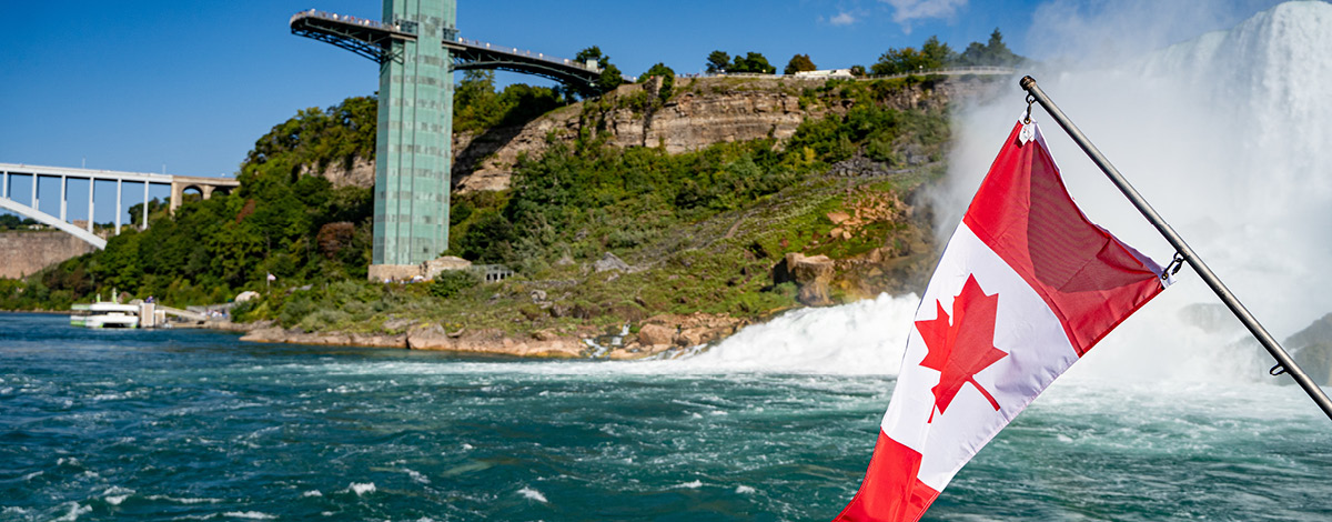 Canadian flag in front of Niagara Falls.