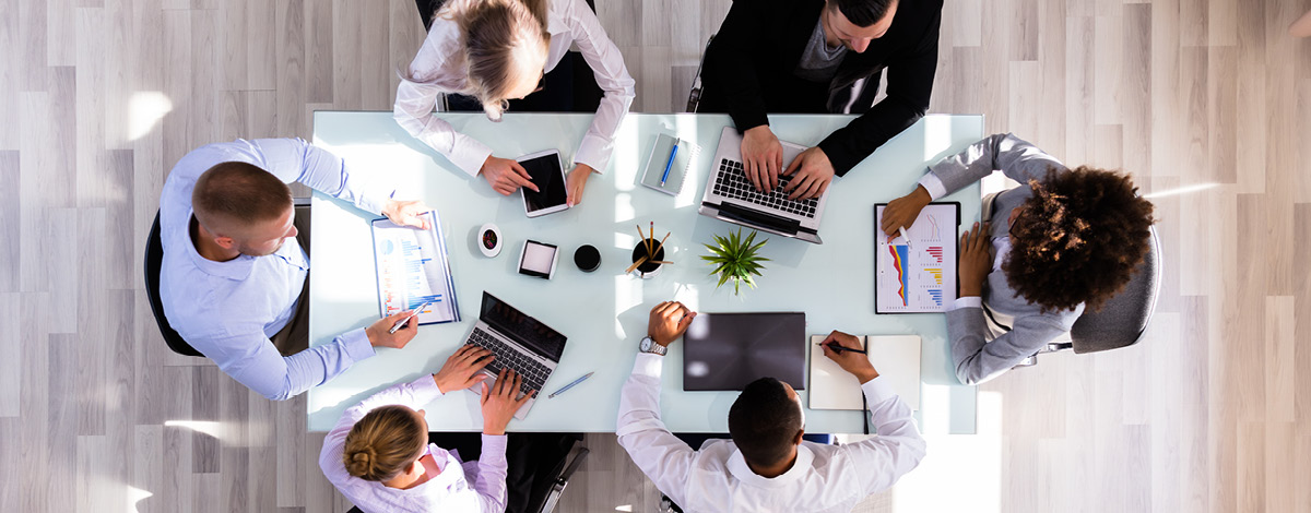 Top-down view of businesspeople working in office.