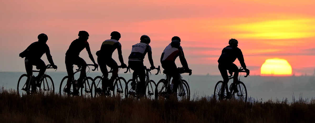 Group bicycle ride at dawn.