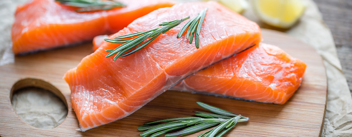 Raw salmon on a wooden board.