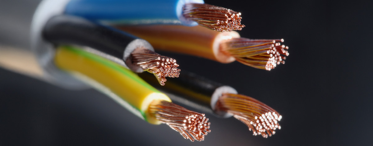 Electrical cables with the outer protective sheath cut, exposing the copper wiring.