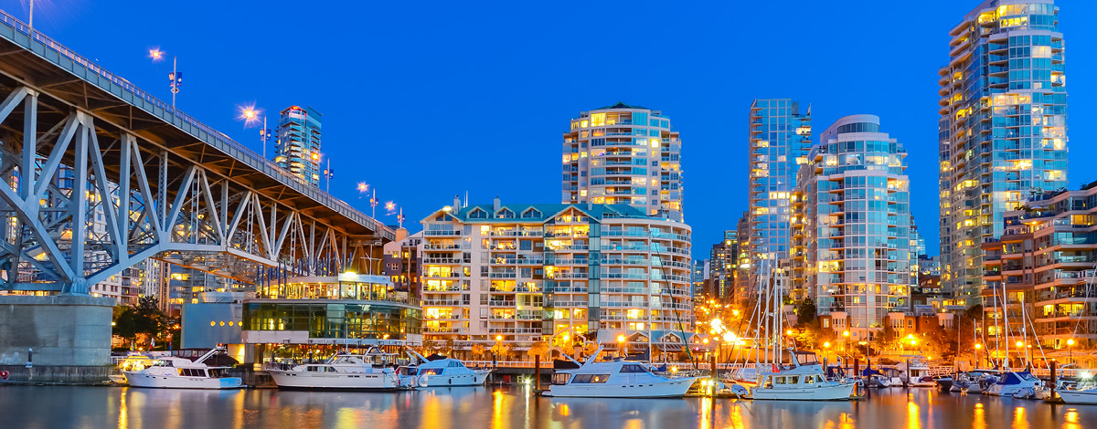Panoramic skyscrapers reflection along False Creek riverside in Vancouver, BC, Canada.