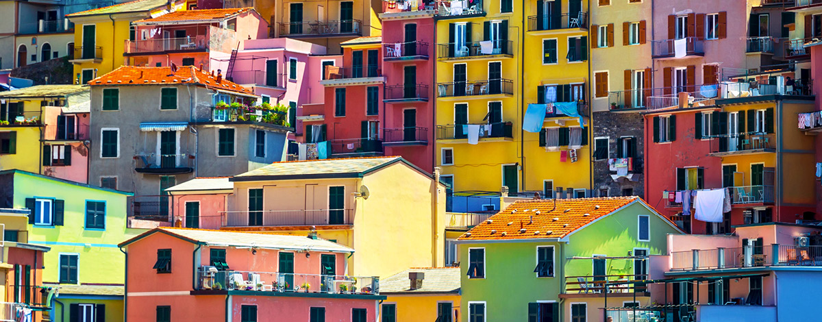 Colorful houses sit on a cliff in Cinque Terre (meaning “Five Lands”), in Liguria, Italy.