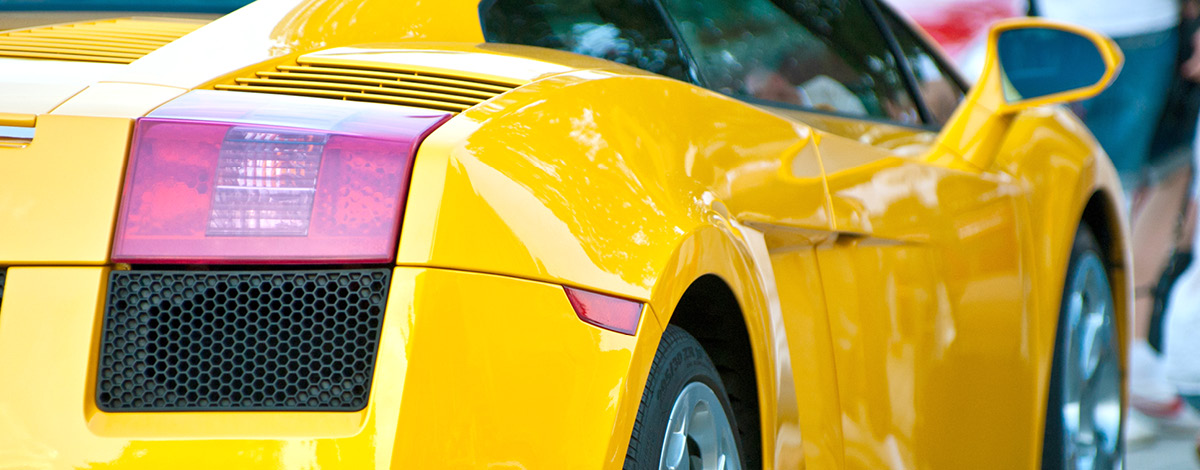 Yellow sportscar parked on the road.